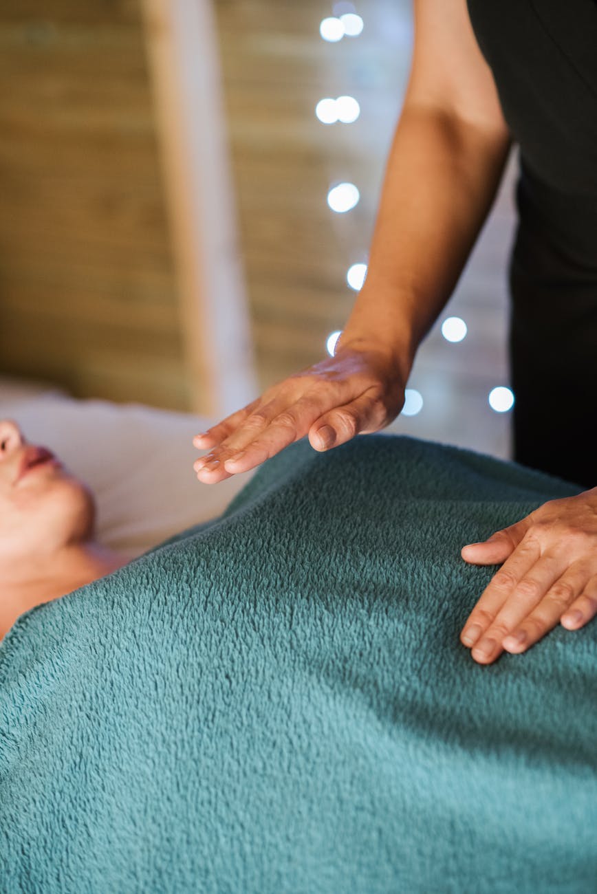 lady enjoying massage from masseur in room